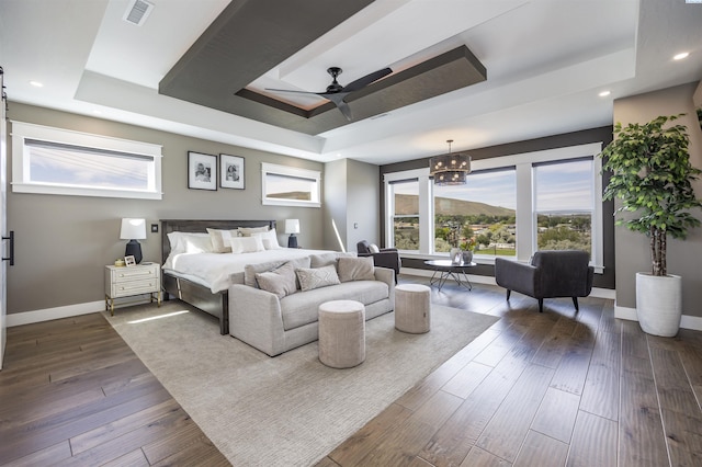 975 Rieve Ct, Richland, WA 99352 - bedroom with a tray ceiling, a chandelier, dark wood-style floors, a ceiling fan, and recessed lighting