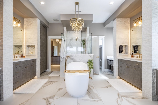 975 Rieve Ct, Richland, WA 99352 - bathroom featuring two vanities, a freestanding tub, walk in shower, recessed lighting, and a chandelier