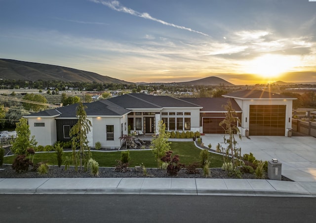 975 Rieve Ct, Richland, WA 99352 - view of front of house with a mountain view, a garage, concrete driveway, and a lawn