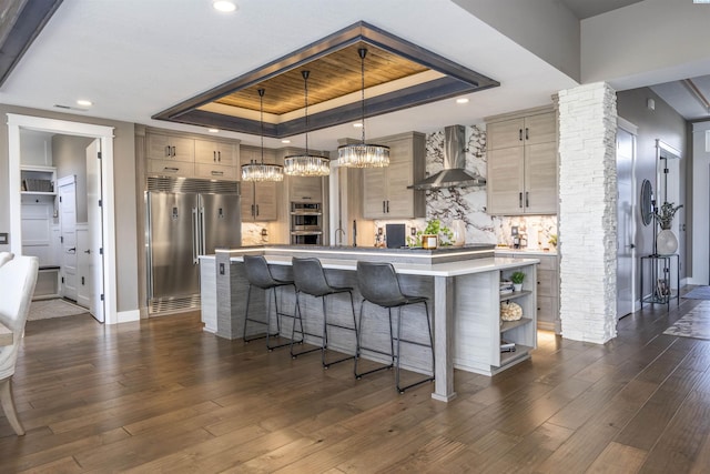 975 Rieve Ct, Richland, WA 99352 - kitchen with stainless steel built in fridge, wall chimney exhaust hood, a tray ceiling, light countertops, and recessed lighting