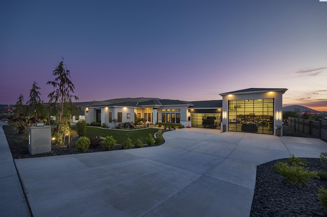 975 Rieve Ct, Richland, WA 99352 - view of front of house featuring concrete driveway, a gate, stucco siding, and an attached garage