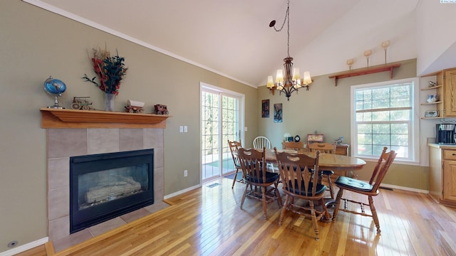 470 NW Robert St, Pullman, WA 99163 - dining room with light wood-type flooring, healthy amount of natural light, vaulted ceiling, crown molding, and a tile fireplace