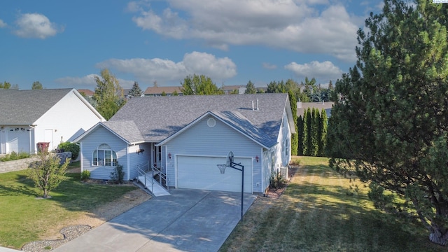 470 NW Robert St, Pullman, WA 99163 - view of front facade featuring an attached garage, driveway, a front yard, and roof with shingles