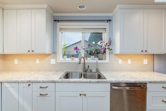 5309 Buchanan Ln, Pasco, WA 99301 - kitchen with stainless steel dishwasher, a sink, light countertops, white cabinetry, and ornamental molding