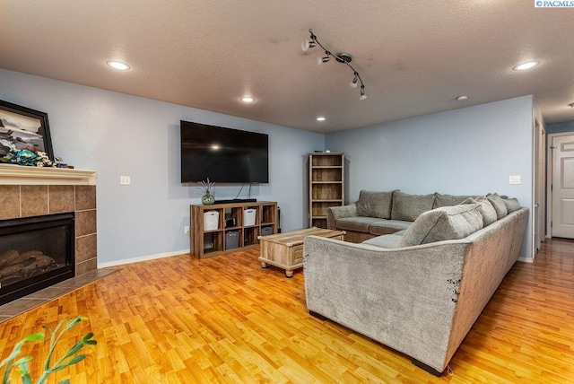 5309 Buchanan Ln, Pasco, WA 99301 - living area with wood finished floors, recessed lighting, baseboards, a textured ceiling, and a fireplace