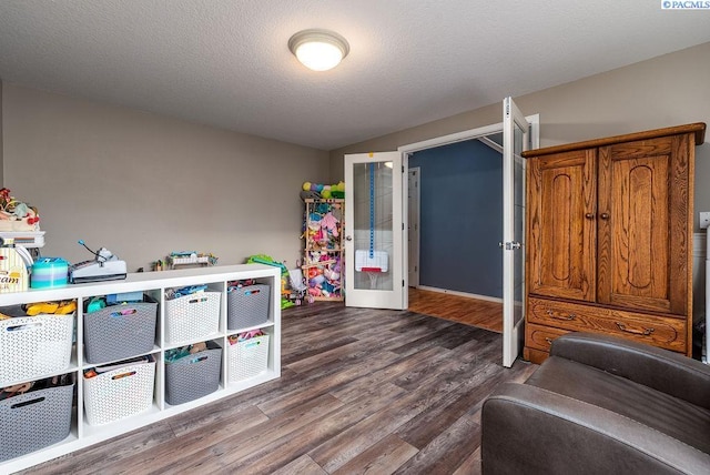 5309 Buchanan Ln, Pasco, WA 99301 - playroom with dark wood-style floors and a textured ceiling