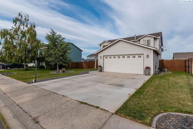 5309 Buchanan Ln, Pasco, WA 99301 - view of front of home featuring concrete driveway and a garage