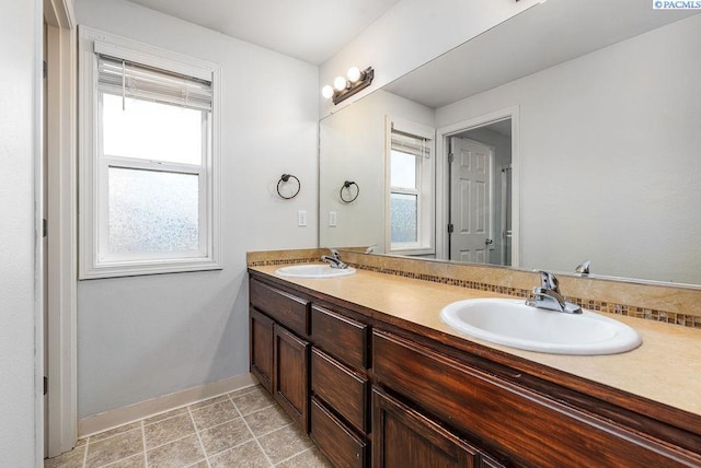 5309 Buchanan Ln, Pasco, WA 99301 - bathroom featuring double vanity, plenty of natural light, and baseboards