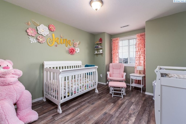 5309 Buchanan Ln, Pasco, WA 99301 - bedroom featuring wood finished floors, a crib, and baseboards