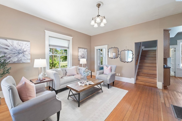 1002 Sherman Ave, Prosser, WA 99350 - living area featuring stairs, a chandelier, healthy amount of natural light, and light wood-type flooring
