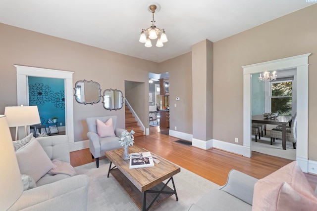 1002 Sherman Ave, Prosser, WA 99350 - living area with a chandelier, light wood-style flooring, and stairs