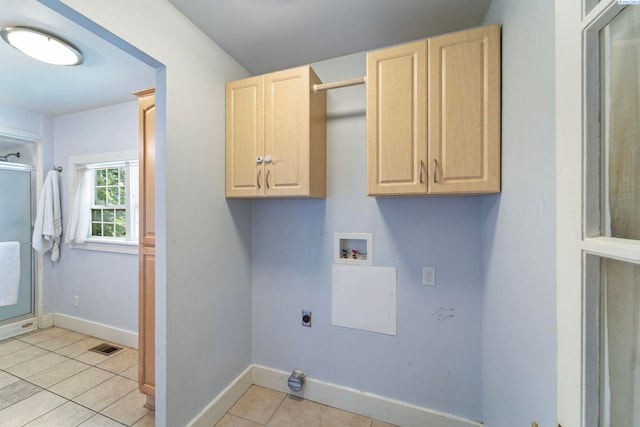 1002 Sherman Ave, Prosser, WA 99350 - washroom with electric dryer hookup, washer hookup, light tile patterned floors, and cabinet space