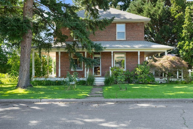1002 Sherman Ave, Prosser, WA 99350 - view of front of home with a front yard, brick siding, and a porch