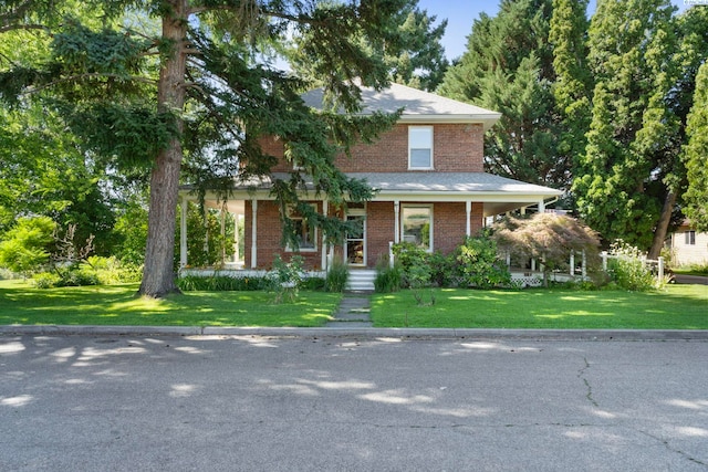1002 Sherman Ave, Prosser, WA 99350 - view of front facade featuring brick siding, a front yard, and covered porch