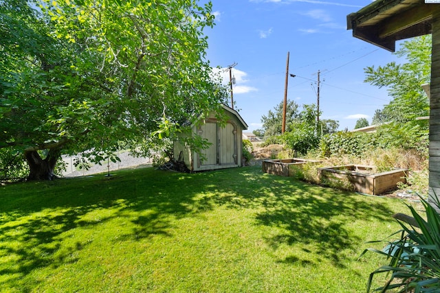 1002 Sherman Ave, Prosser, WA 99350 - view of green lawn featuring a storage shed and a garden