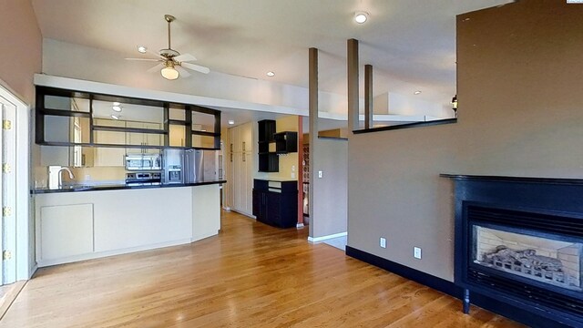 1000 SE Sunnymead Way, Pullman, WA 99163 - kitchen with stainless steel appliances, dark countertops, light wood-style flooring, and a ceiling fan