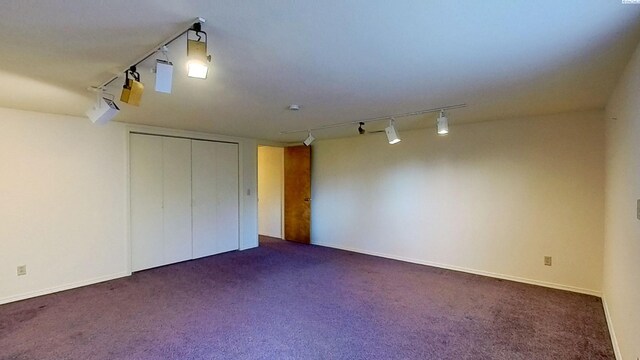 1000 SE Sunnymead Way, Pullman, WA 99163 - unfurnished bedroom featuring rail lighting, dark colored carpet, and a closet