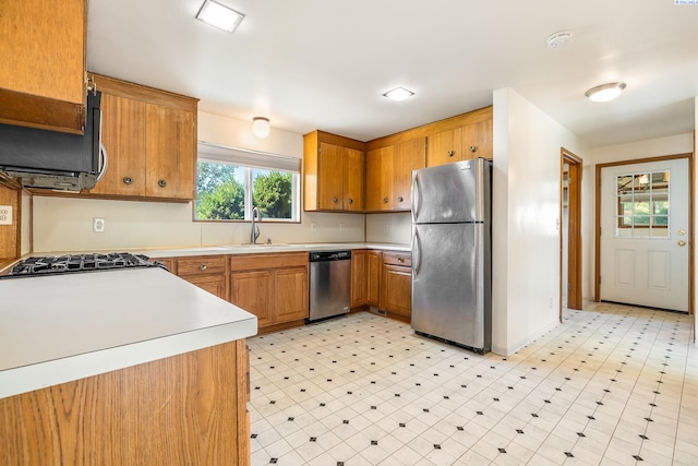 2214 W Clearwater Ave, Kennewick, WA 99336 - kitchen featuring stainless steel appliances, light countertops, light flooring, and brown cabinets