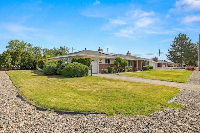 2214 W Clearwater Ave, Kennewick, WA 99336 - ranch-style house featuring roof mounted solar panels, a garage, driveway, and a chimney