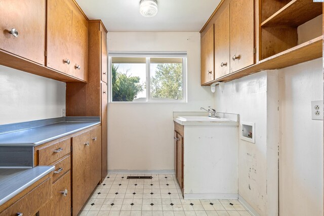 2214 W Clearwater Ave, Kennewick, WA 99336 - laundry area with washer hookup, cabinet space, light floors, and baseboards