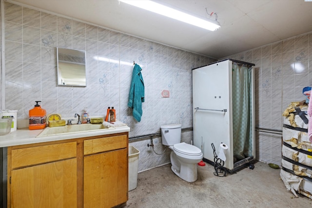 full bathroom with vanity, a shower with shower curtain, concrete floors, tile walls, and toilet