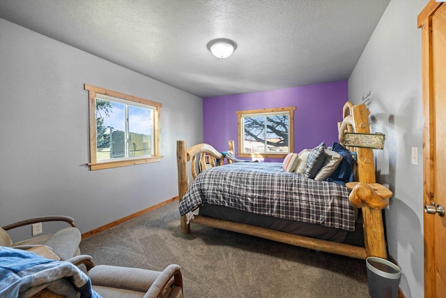 carpeted bedroom featuring a textured ceiling and baseboards