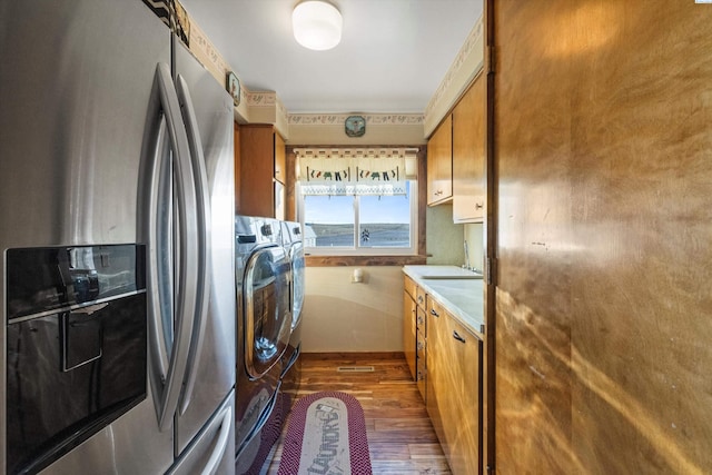 laundry area featuring washer and dryer, laundry area, and dark wood-type flooring