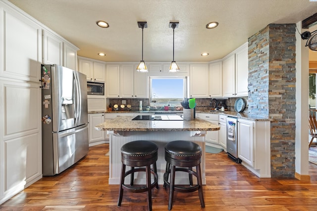 kitchen featuring backsplash, appliances with stainless steel finishes, and white cabinetry