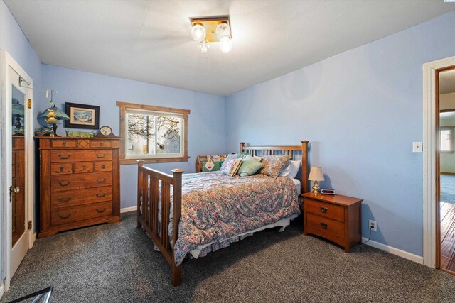 carpeted bedroom with baseboards