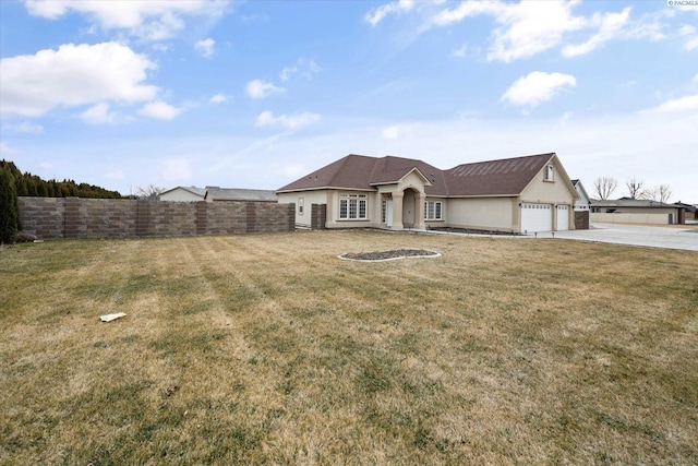 ranch-style house featuring a front yard and a garage