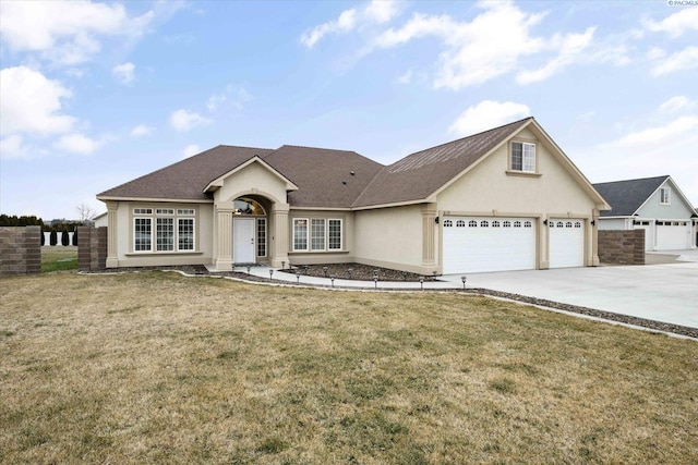 view of front of house with a front yard and a garage