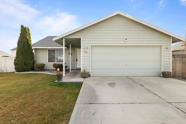 ranch-style house featuring a garage and a front lawn