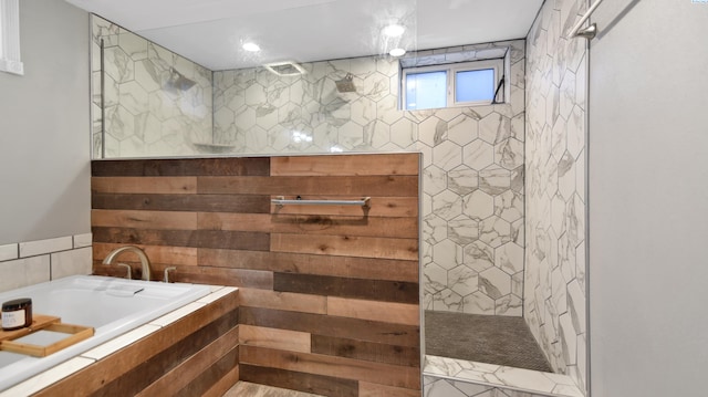 bathroom featuring visible vents, a bath, and a walk in shower