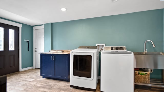 laundry room with recessed lighting, a sink, baseboards, cabinet space, and washer and clothes dryer