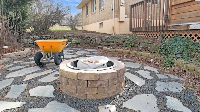 exterior details with a fire pit and brick siding