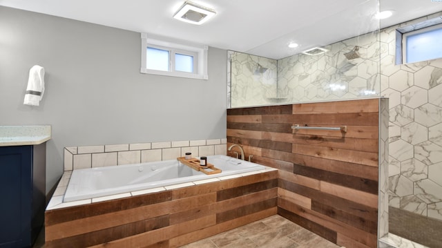 full bath featuring a walk in shower, vanity, and a bath