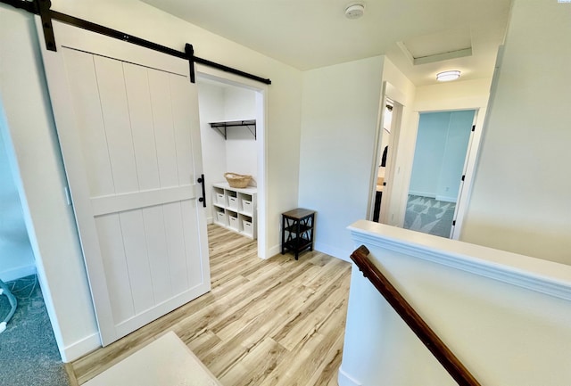 4516 NW Commons Dr, Pasco, WA 99301 - corridor featuring a barn door, light wood-type flooring, and attic access