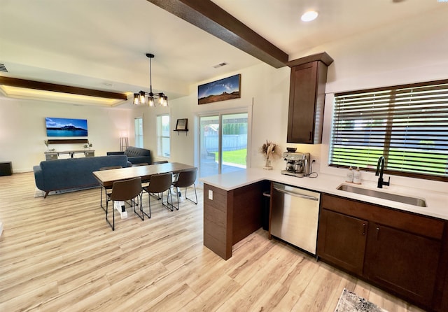 4516 NW Commons Dr, Pasco, WA 99301 - kitchen featuring dishwasher, dark brown cabinets, open floor plan, light countertops, and light wood-style flooring