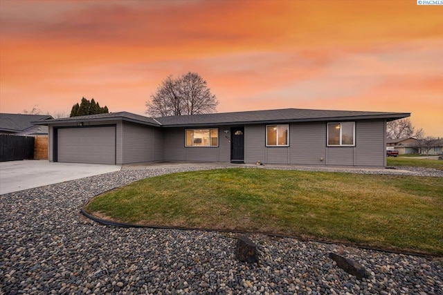 view of front of property with a garage and a lawn