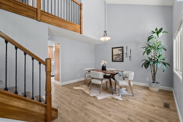 4214 W Klamath Ave Unit B-2, Kennewick, WA 99336 - dining room featuring a high ceiling, stairway, baseboards, and light wood-style floors