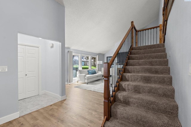 4214 W Klamath Ave Unit B-2, Kennewick, WA 99336 - stairs featuring wood finished floors, high vaulted ceiling, a textured ceiling, and baseboards