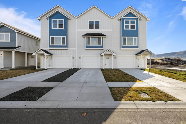 125 Claret Dr, Prosser, WA 99350 - view of front of house featuring driveway, an attached garage, a mountain view, and board and batten siding