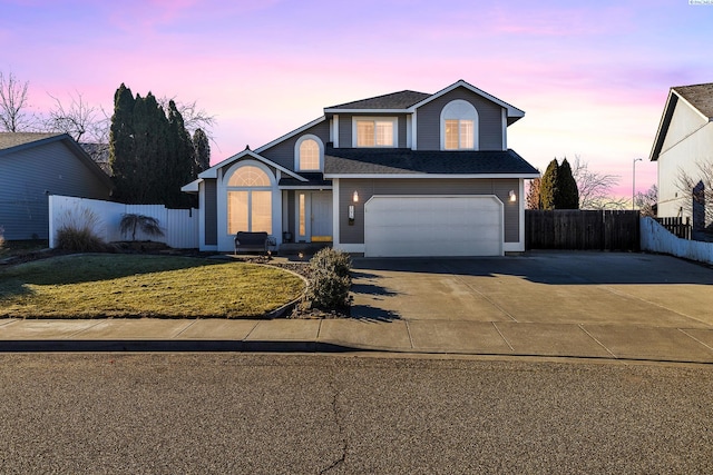 front of property featuring a garage and a lawn