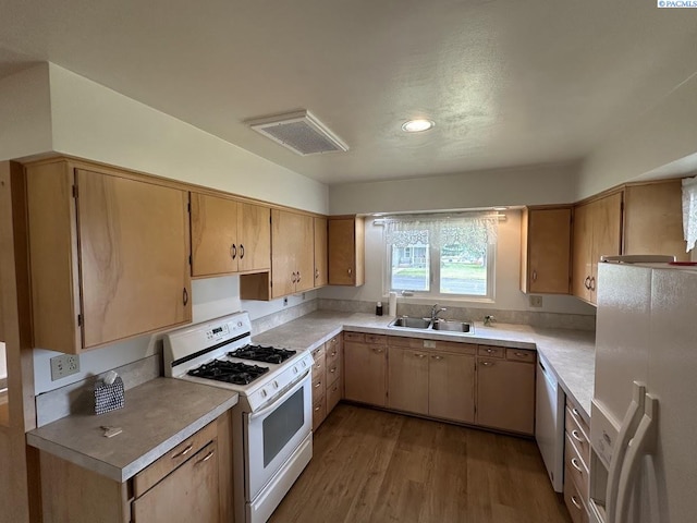 404 D St, Endicott, WA 99125 - kitchen featuring white appliances, wood finished floors, and light countertops