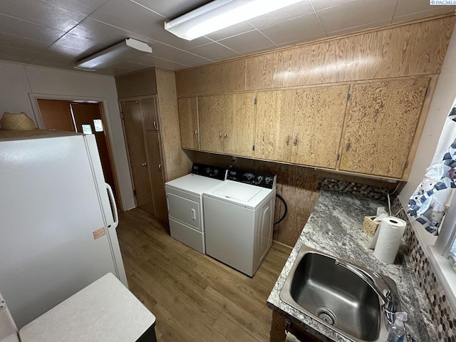 404 D St, Endicott, WA 99125 - washroom with separate washer and dryer, light wood finished floors, and cabinet space