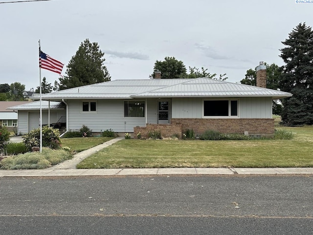 404 D St, Endicott, WA 99125 - ranch-style house with a chimney, a front yard, and a metal roof