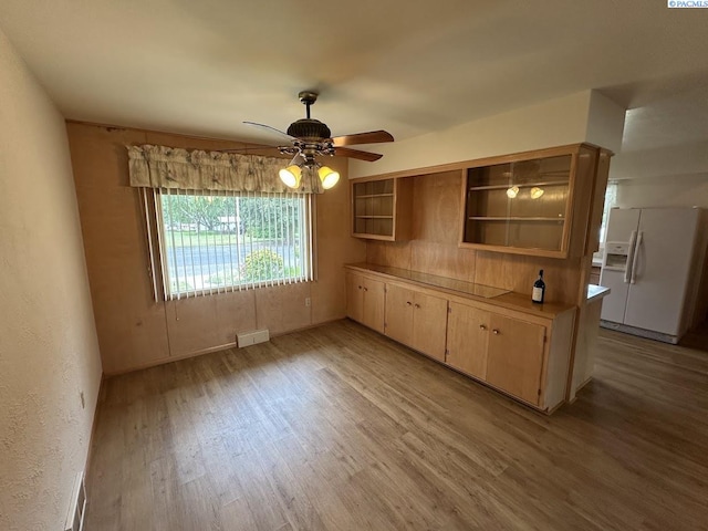 404 D St, Endicott, WA 99125 - kitchen featuring white refrigerator with ice dispenser, light wood-type flooring, ceiling fan, light countertops, and open shelves