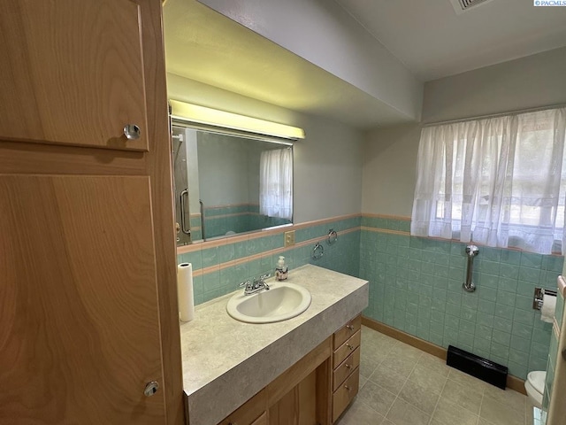 404 D St, Endicott, WA 99125 - bathroom with vanity, tile walls, and wainscoting