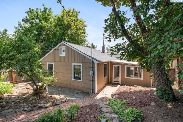 312 NW Harrison St, Pullman, WA 99163 - view of front of home featuring a patio, a chimney, and roof with shingles