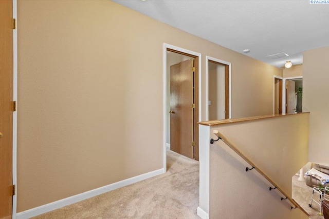 5001 E Killdeer Ct, West Richland, WA 99353 - corridor featuring an upstairs landing, light colored carpet, and baseboards